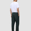 En man sedd bakifrån, klädd i en vit t-shirt och Ease Pants Relaxed Fit Northern Pine i skandinavisk design.