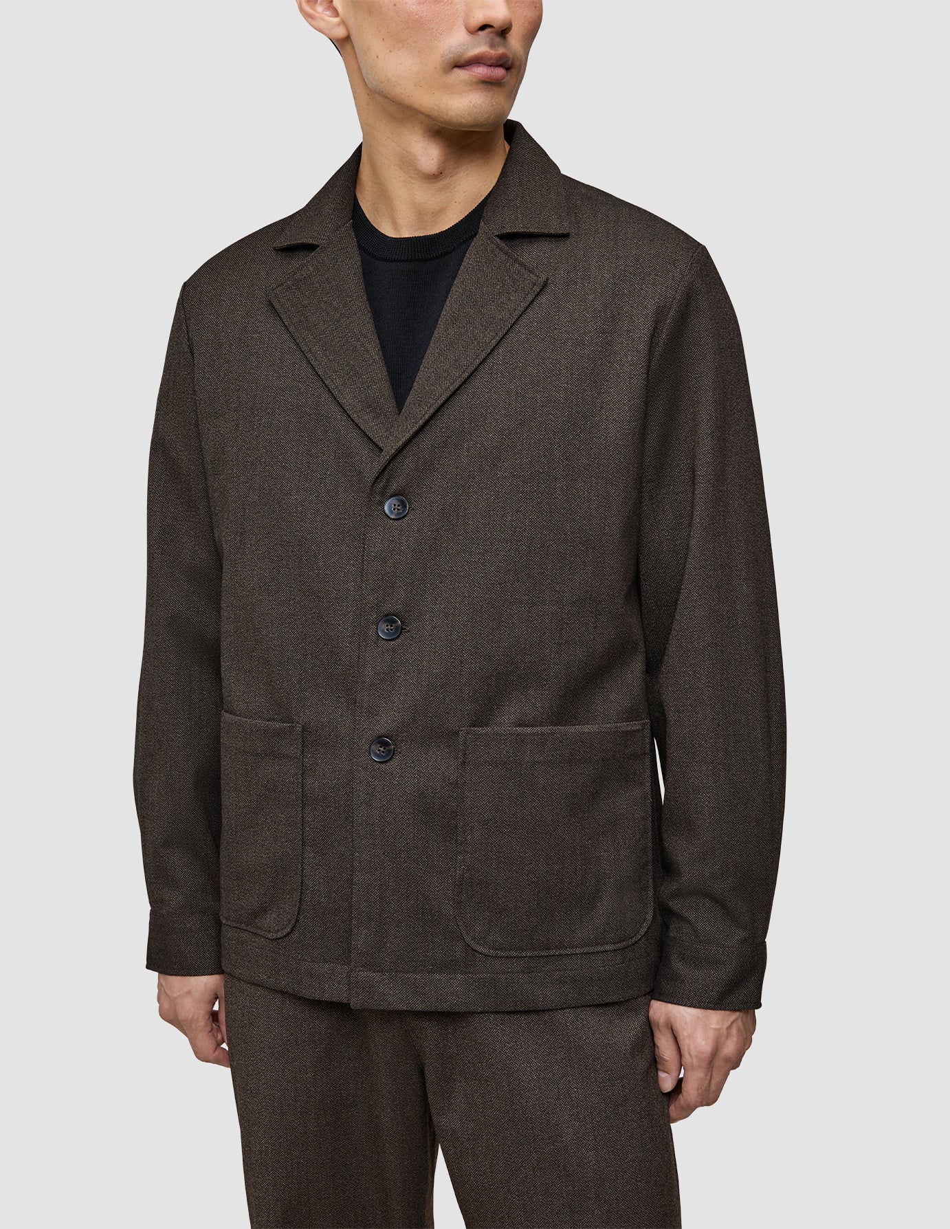 Atelier-överskjorta i mörkbrun bruten twill med skårad krage, tre knappar och två stora påsydda fickor.