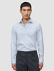 En man i en ljusblå och vitrandig Elevated Shirt Slim Classic Blue Striped tillsammans med mörkgrå byxor.