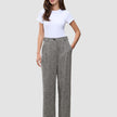 En kvinna bär en vit t-shirt och byxorna Women Ashryn Pants Wide Domino Herringbone i en skandinavisk stil.