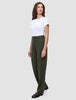 En kvinna bär en vit t-shirt instoppad i ett par högmidjade Women GO2 Pants Straight i färgen Dusty Olive samt mörka loafers.