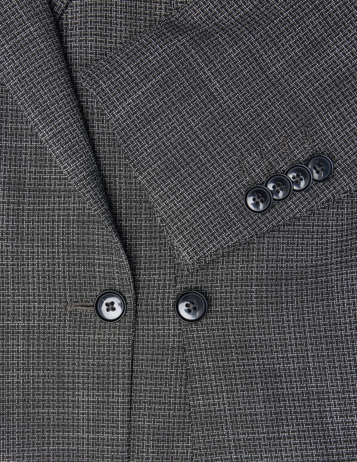 Närbild på damblazern Nara Blazer Fitted Black Check i svartvitt rutmönster med svarta knappar.