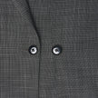 Närbild på Women Nara Blazer Fitted Black Check, en mörkgrå kavaj med ett diskret vitt rutmönster och två svarta knappar.